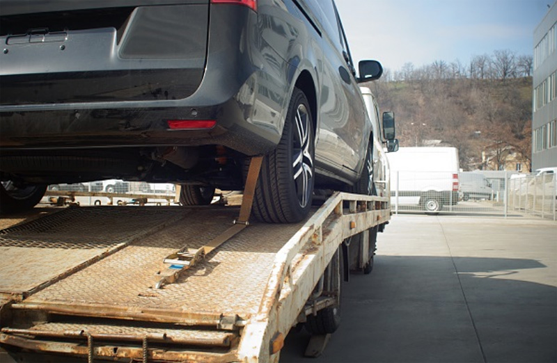 car being towed in truck bed