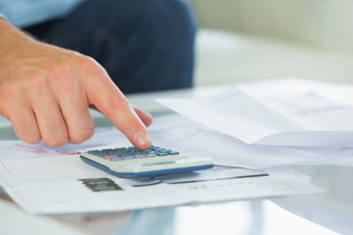 man calculating credit card debt