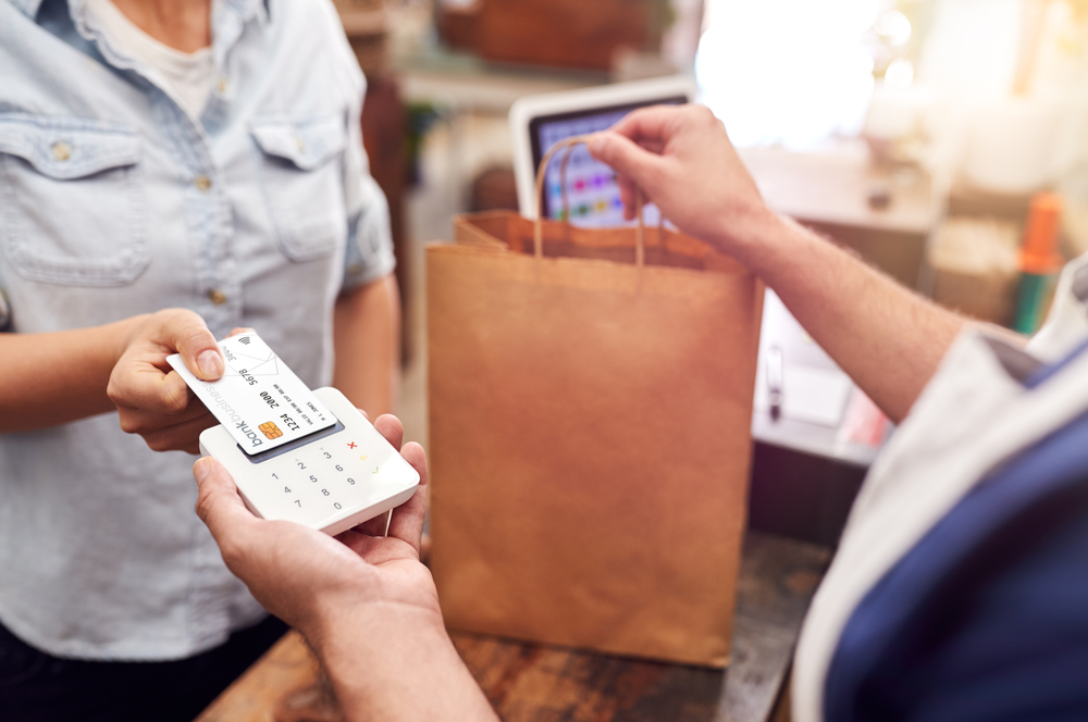 Woman using credit card to help build credit