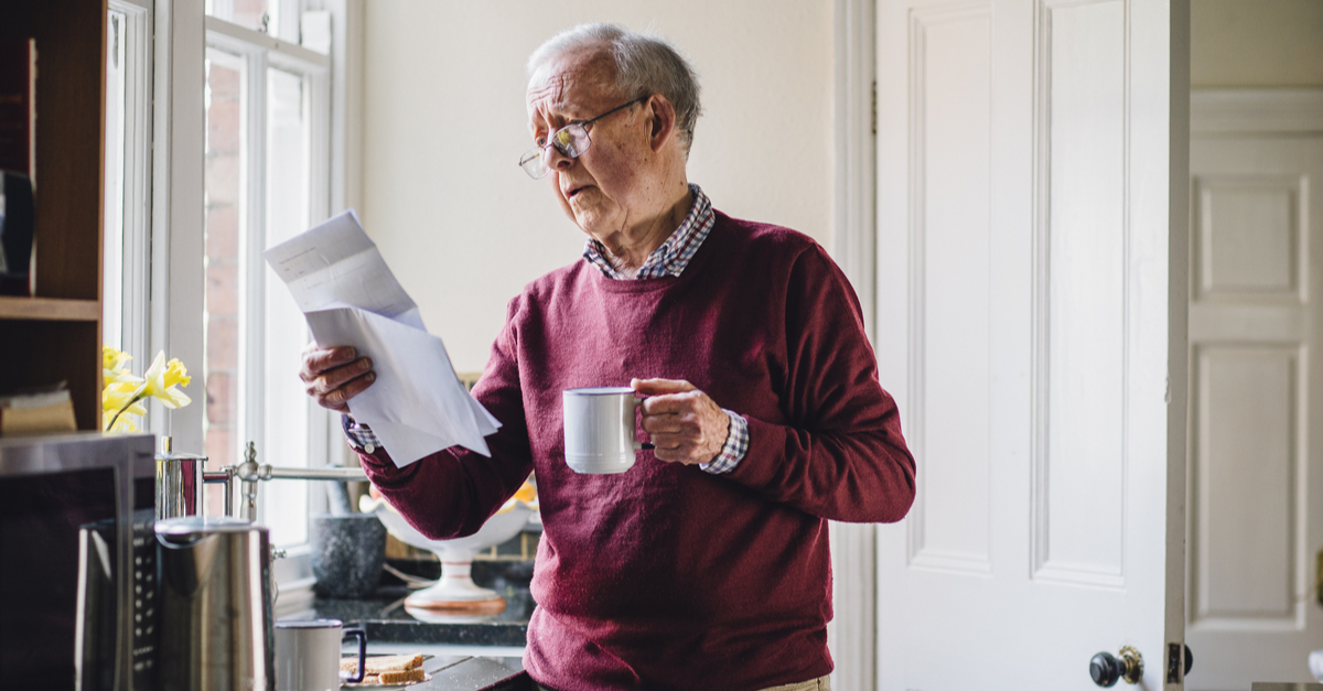 Senior man reading a foreclosure notice