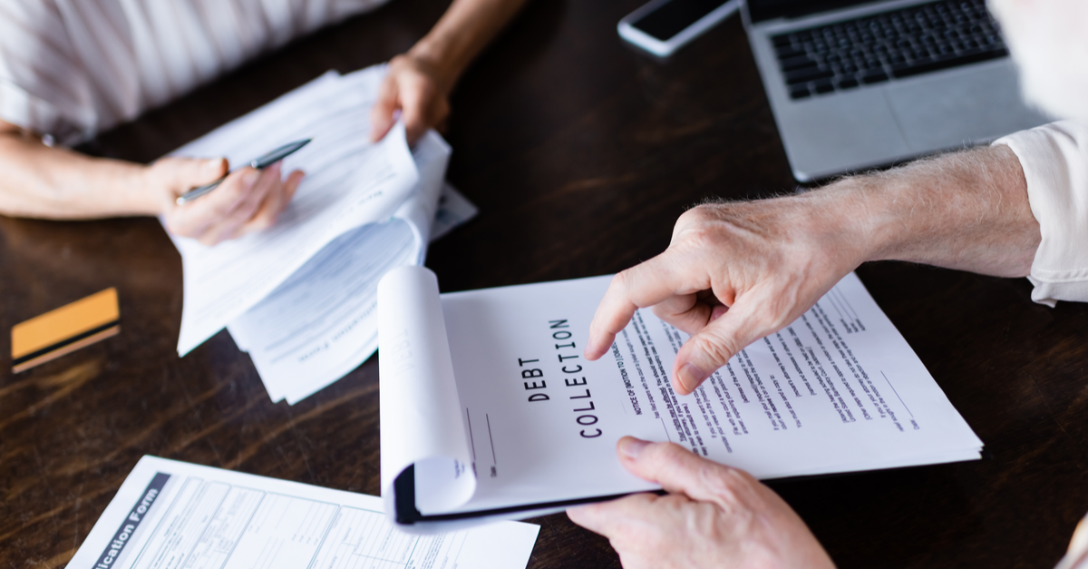 senior man pointing to a debt collection paper