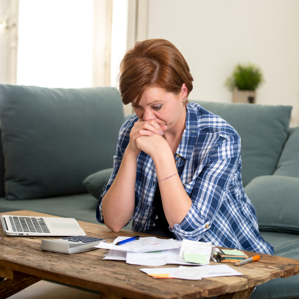 worried woman with credit cards on the table.