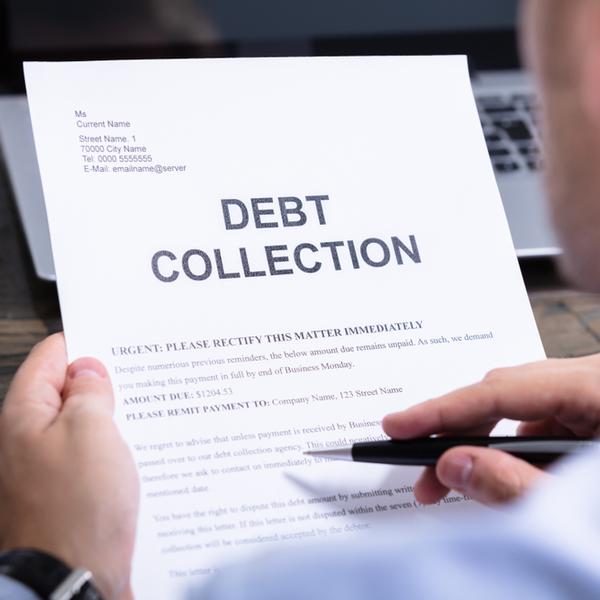 man reading debt collection notice letter