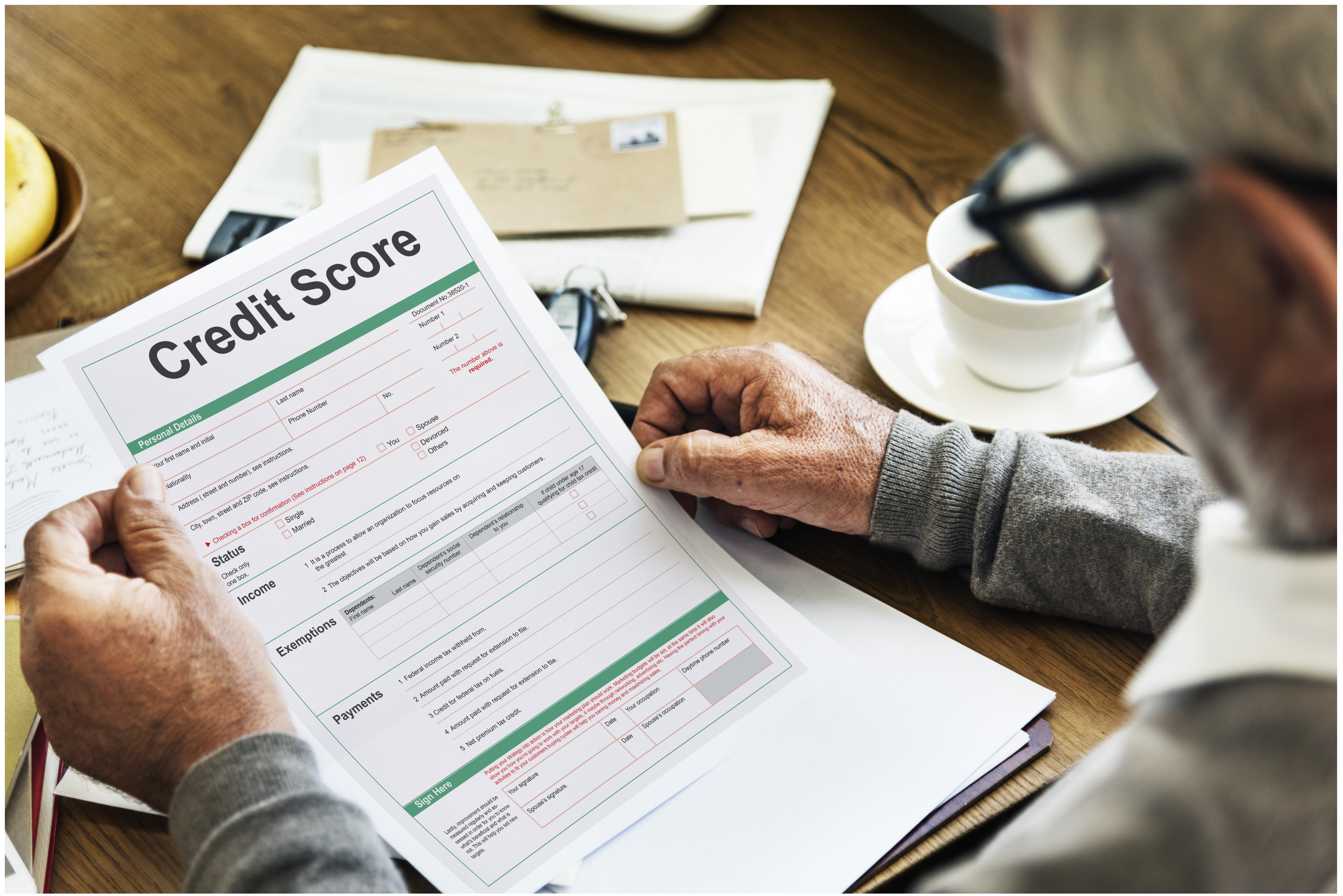 An old man looking at a credit score document