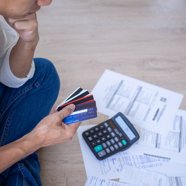 A man stressed looking at credit cards