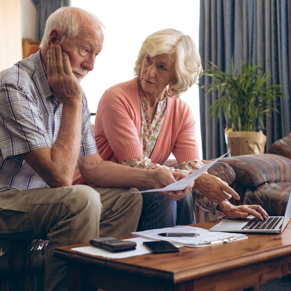 a senior couple looking at medical bills