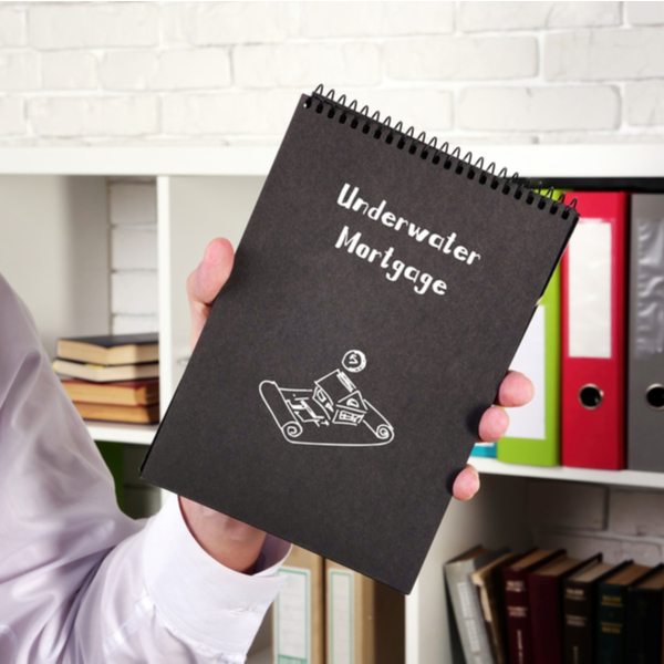 a man holding an underwater notebook