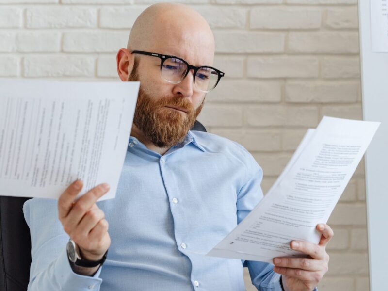 man sitting in a chair reviewing a Florida debt collection lawsuit